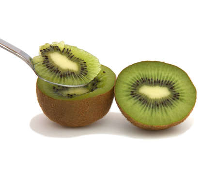 A halve of a kiwi and a spoonの写真素材