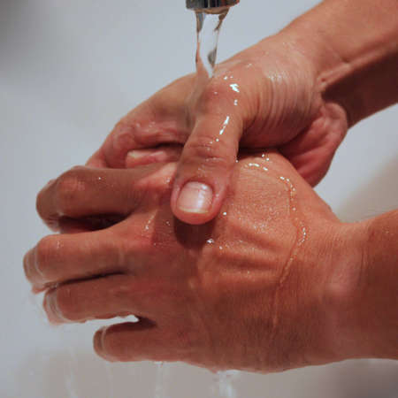 Male hands washed with waterの写真素材