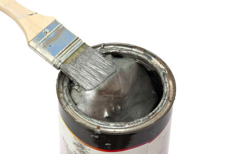 Brush with fresh paint on a color pot over whiteの写真素材