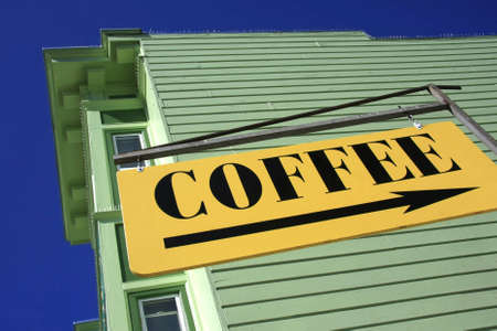 Yellow sign pointing towards Coffeeの写真素材