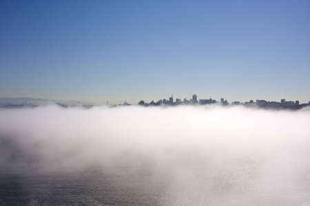 San Francisco skyline from Golden Gate Bridge with fog in the morningの写真素材