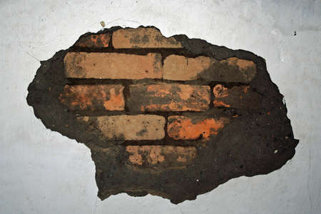 A wall with damaged wall plasterの写真素材