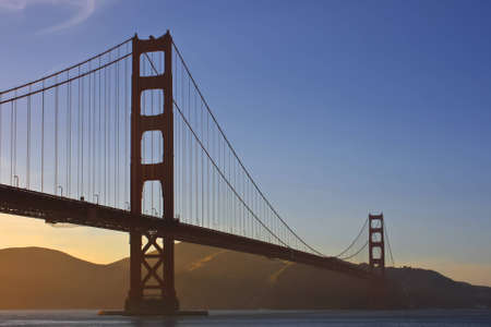 Golden Gate Bridge during sunset with light fogの写真素材