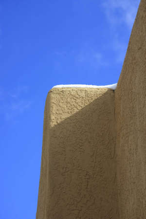 Detail of a adobe building in sunny springtime with snowの写真素材