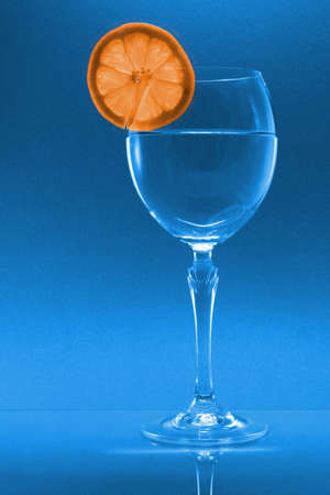 A wine glass with an orange sliceの写真素材