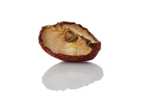 An old dried quarter of a red appleの写真素材