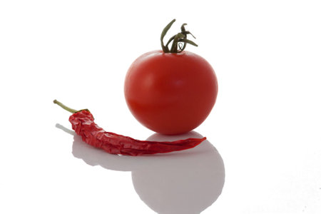 A tomato and a red dried chileの写真素材
