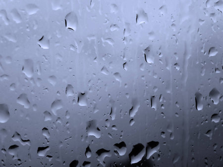 Raindrops on a window on a cloudy dayの写真素材