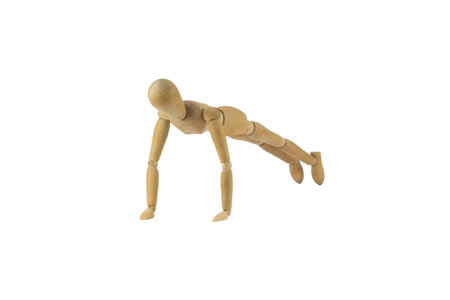 Wooden female figure is doing pushupsの写真素材