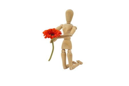A wooden female doll is making a proposalの写真素材