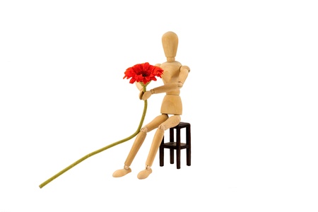 A wooden female doll is making a proposalの写真素材