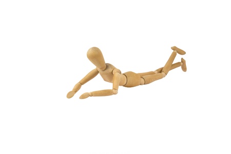 A wooden female doll on her belly feet movingの写真素材