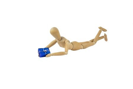 A wooden female doll is holding a giftの写真素材