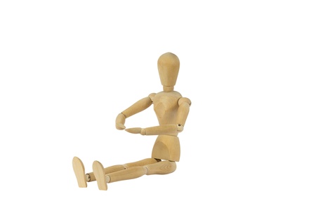 A wooden female doll sitting and looking on her palmsの写真素材