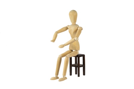 A wooden female doll is pushing something awayの写真素材