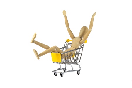 A happy wooden female doll in a shopping cartの写真素材