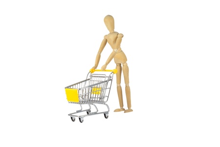 A wooden female doll is pushing a shopping cartの写真素材