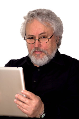 A senior with grey hair is holding a tablet and looking suspiciousの写真素材