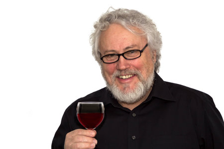 A senior is doing wine tastingの写真素材
