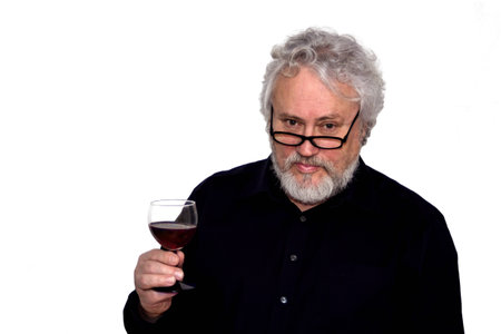 A senior is doing wine tastingの写真素材