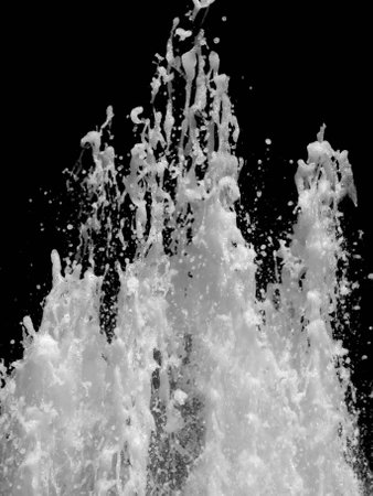 Vertical shot of splashing water isolated on black backgroundの写真素材