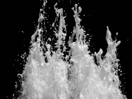 Horizontal shot of splashing water isolated on black backgroundの写真素材