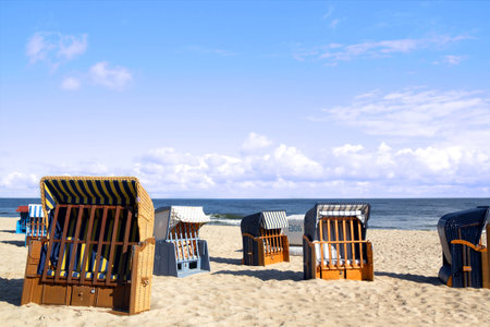 Empty roofed wicker beach chairs at the Usedom beachの写真素材