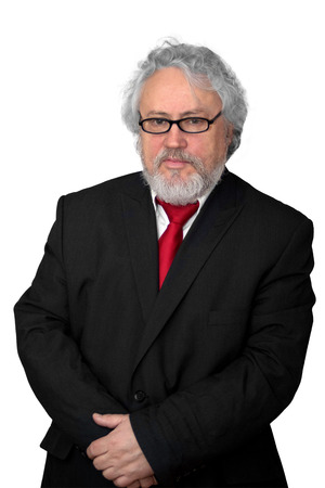 Grey haired senior wearing a dark suit and a red necktieの写真素材