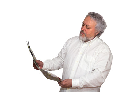 Senior is looking at a map he is holding in his handsの写真素材