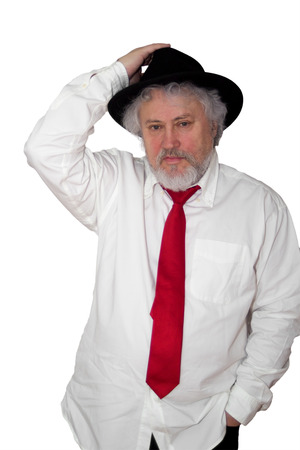 Standing senior with white shirt red necktie and lifting his dark hatの写真素材