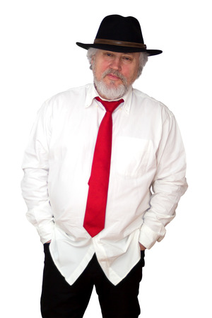 Standing senior with white shirt red necktie and dark hatの写真素材