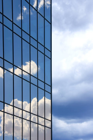 Reflections of clouds and sky on a shiny surface over skyの写真素材