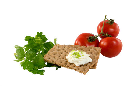 Crispbread with cream cheese, herbs and tomatoesの写真素材