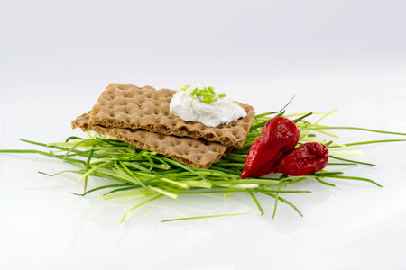 Crispbread with cream cheese chives and chileの写真素材