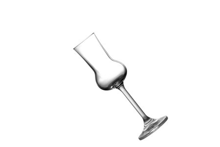 A tilted empty grappa glass isolated on whiteの写真素材
