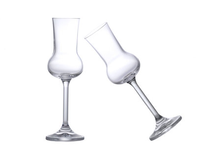 Two empty Grappa glasses one tilted one standingの写真素材