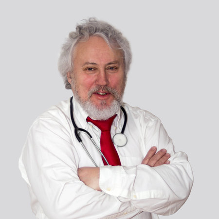 A gray haired and bearded doctor looking friendlyの写真素材