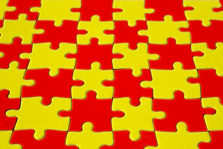 Colored red and yellow completed puzzle of paper in low angle shotの写真素材