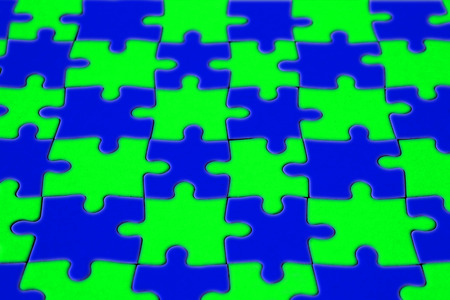 Colored blue and green completed puzzle of paper in low angle shotの写真素材