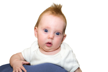 An almost four month old baby girl on white background looking excitedの写真素材