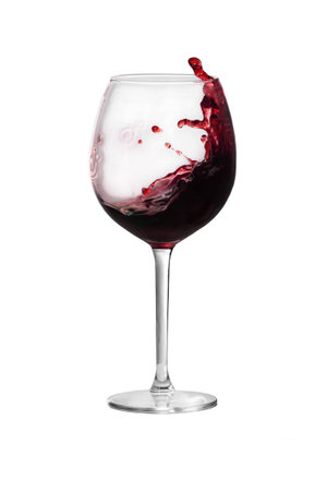 Red wine is splashing out of a wine glassの写真素材