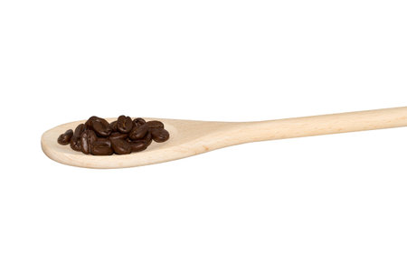 Coffeebeans on a wooden spoon isolated on whiteの写真素材