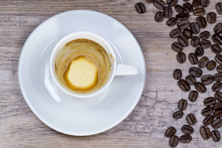 Empty espresso on wooden table with blurred background from aboveの写真素材
