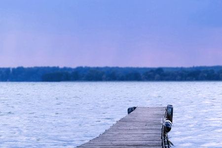 Dreamy tilt-shift picture of a pier leading into a lakeの写真素材