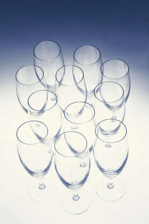 Empty champagne glasses from above on blue fading backgroundの写真素材