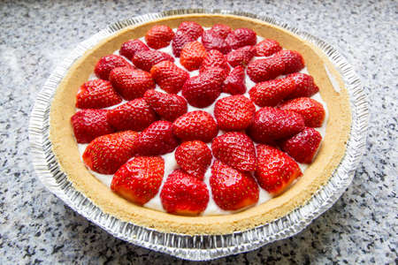 Fresh strawberry cream cheese pie from above on kitchen counterの写真素材