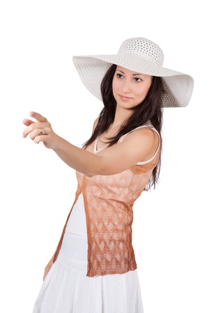 Brunette woman in white sun hat in a white dress, on white background, someone selects and shows his fingerの写真素材