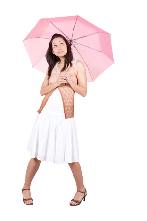 Brunette woman in a white dress with pink umbrella, isolated on white backgroundの写真素材