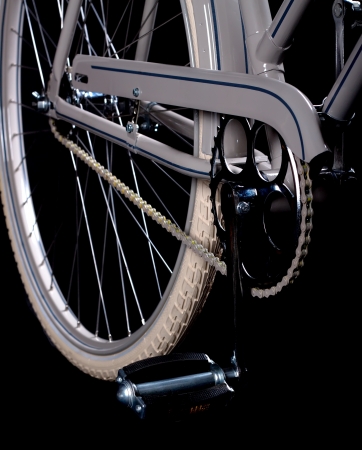 Old refurbished retro bike isolated on black background detail view of gears with chain and pedalsの写真素材