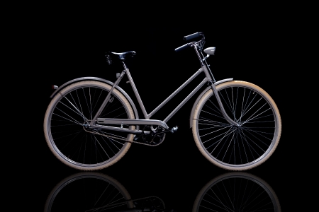 Old refurbished retro bike isolated on black background with reflection side viewの写真素材